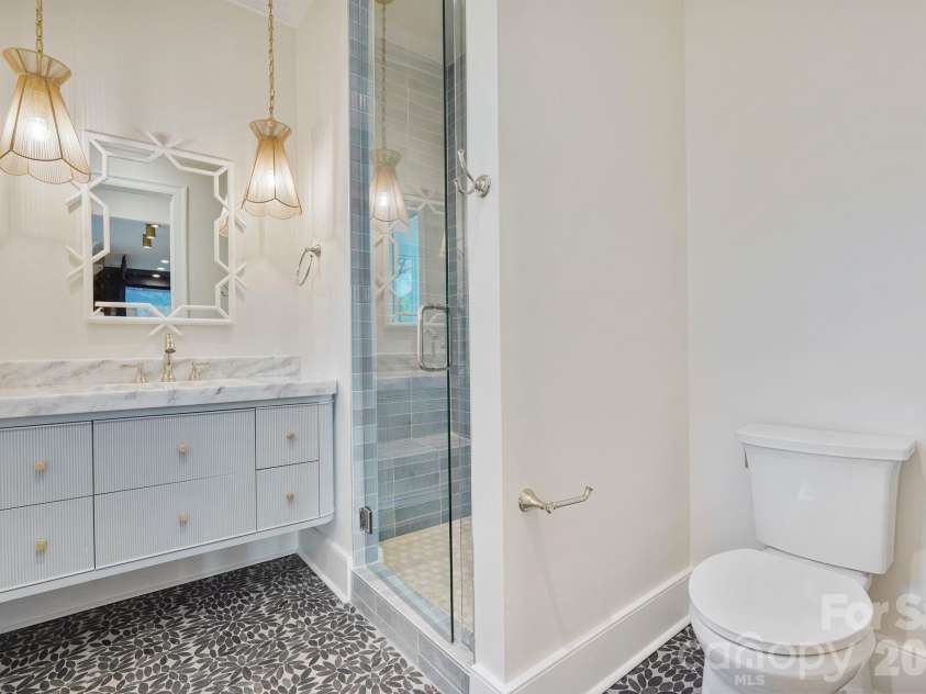 21216 Rio Oro Drive, Cornelius, NC 28031.  MLS# CAR4425303, YatesRealty ID 45943. Thoughtfully designed basement bath provides convenient access from the outdoor living areas, helping keep wet traffic contained on the lower level, with a dedicated laundry room located just steps away.