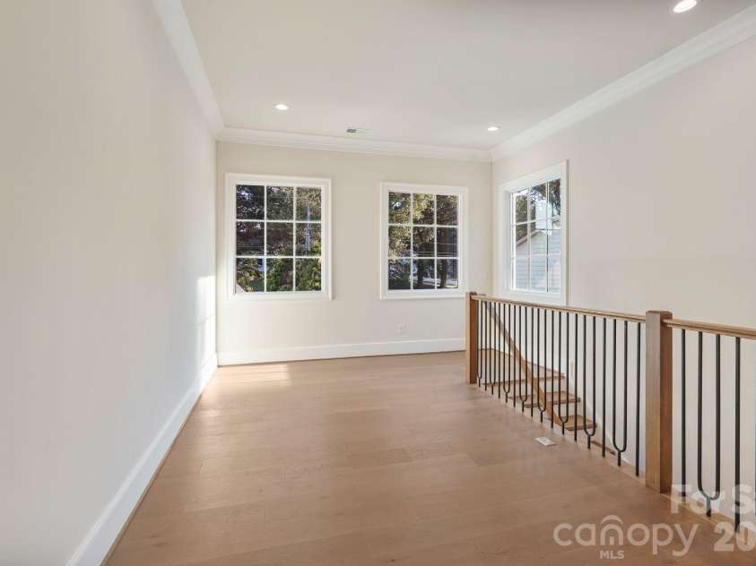 21216 Rio Oro Drive, Cornelius, NC 28031.  MLS# CAR4425303, YatesRealty ID 45943. Upstairs gallery filled with natural light from expansive windows, creating an open, airy transition while capturing beautiful main-channel water views.