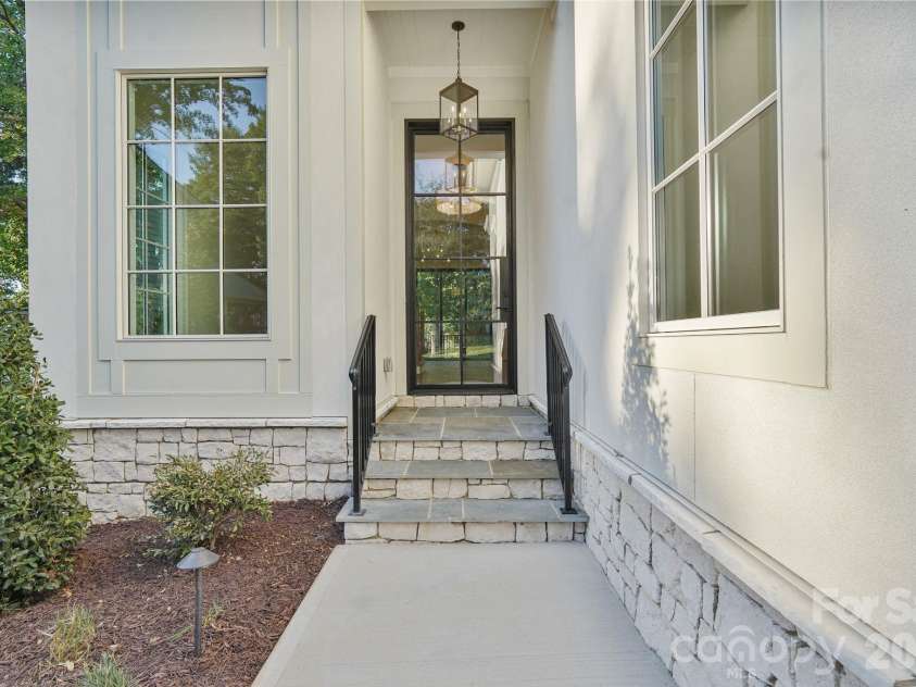 21216 Rio Oro Drive, Cornelius, NC 28031.  MLS# CAR4425303, YatesRealty ID 45943. Welcoming front porch featuring timeless flagstone steps, adding natural texture and an elevated finish to the home’s grand entrance.