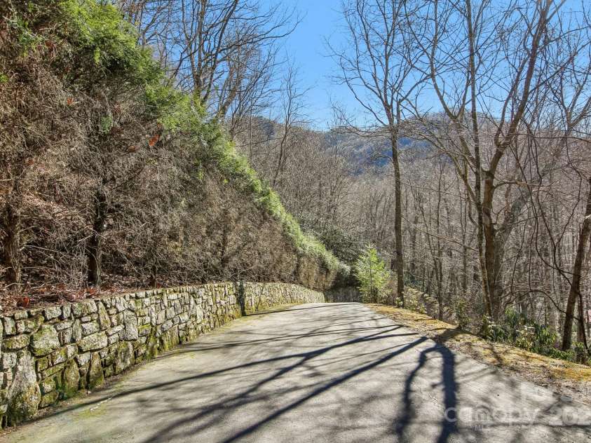 821 Summit Drive, Maggie Valley, NC 28751.  MLS# CAR4225220, YatesRealty ID 4600. Hemlock and stone lined private driveway