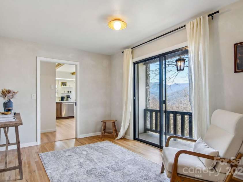 821 Summit Drive, Maggie Valley, NC 28751.  MLS# CAR4225220, YatesRealty ID 4600. Sitting room with sliding glass view
