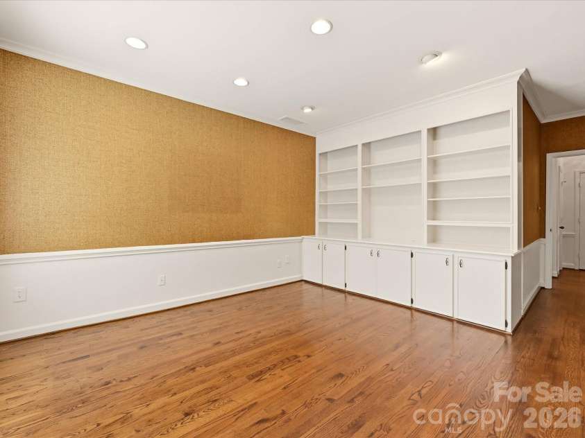 806 Cherokee Road, Charlotte, NC 28207.  MLS# CAR4415796, YatesRealty ID 46018. Cabinets and shelving in den