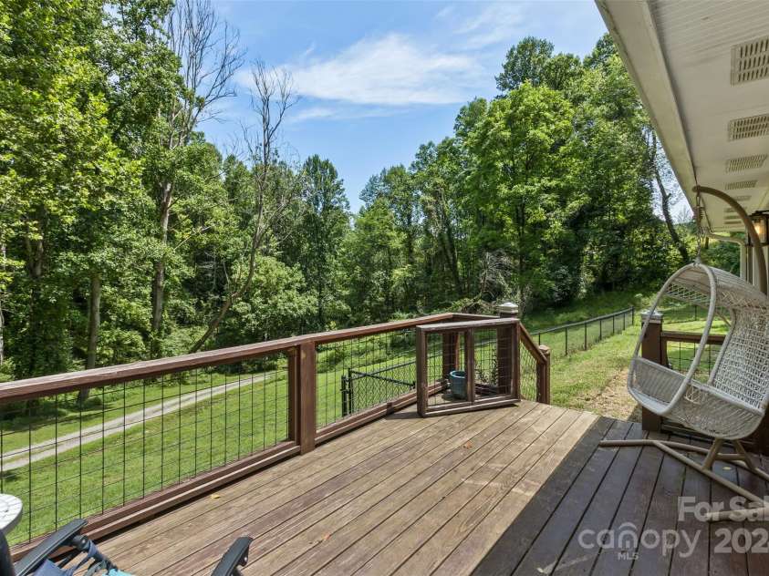 3882 New Leicester Highway, Leicester, NC 28748.  MLS# CAR4168284, YatesRealty ID 4603. Front deck view with fenced side yard for fur babies