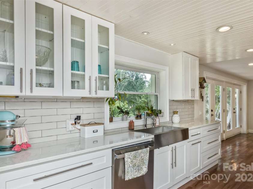 3882 New Leicester Highway, Leicester, NC 28748.  MLS# CAR4168284, YatesRealty ID 4603. Kitchen counter with view toward deck doors