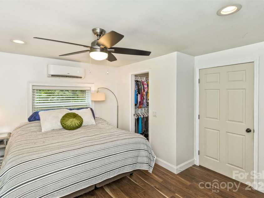 3882 New Leicester Highway, Leicester, NC 28748.  MLS# CAR4168284, YatesRealty ID 4603. Primary bedroom, showing open door to walk-in closet