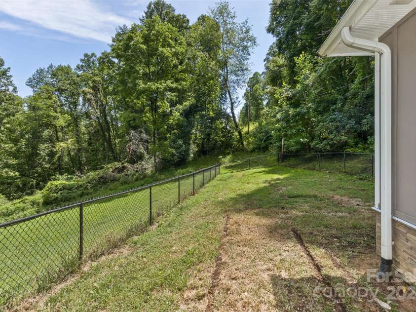 3882 New Leicester Highway, Leicester, NC 28748.  MLS# CAR4168284, YatesRealty ID 4603. Showing fenced side yard