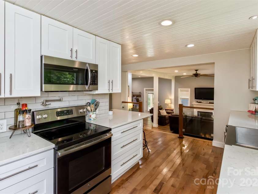 3882 New Leicester Highway, Leicester, NC 28748.  MLS# CAR4168284, YatesRealty ID 4603. View of kitchen back towards living room