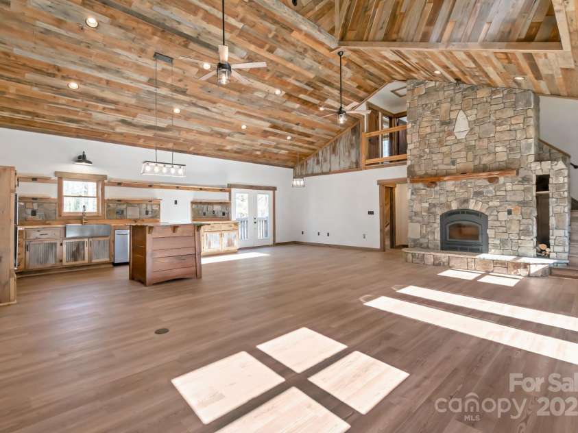 486 Hunter-Lysik Way, Laurel Springs, NC 28644.  MLS# CAR4325096, YatesRealty ID 4607. Great Room with Cathedral Ceilings and Soaring Stone Fireplace