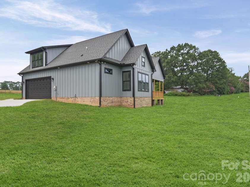 4515 Marvin Simpson Road, Marshville, NC 28103.  MLS# CAR4411738, YatesRealty ID 46083. Grass is AI generated