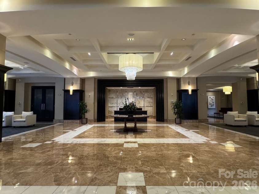 230 Tryon Street, Charlotte, NC 28202.  MLS# CAR4321048, YatesRealty ID 4611. Lobby & Concierge Desk coming in from S Tryon St