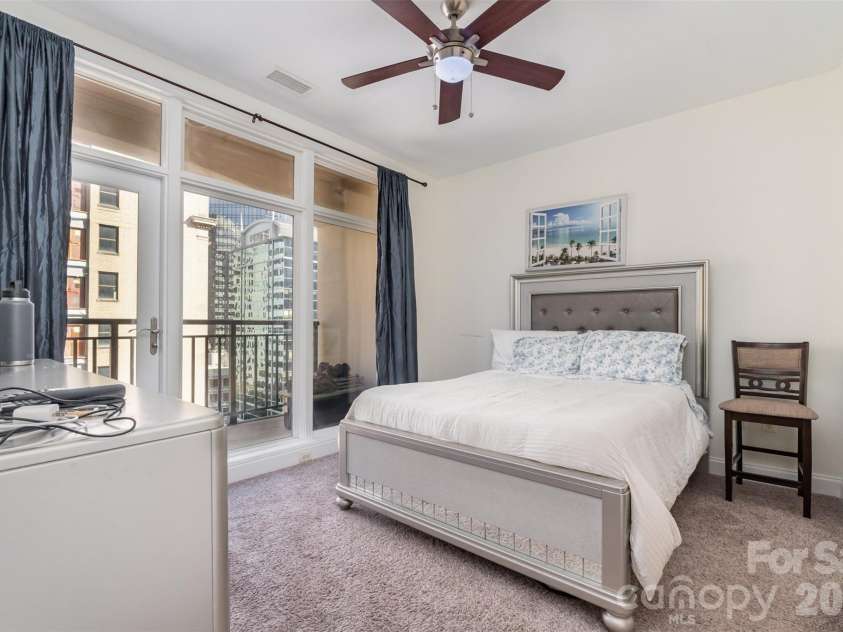 230 Tryon Street, Charlotte, NC 28202.  MLS# CAR4321048, YatesRealty ID 4611. Primary Bedroom with floor to ceiling windows / balcony access