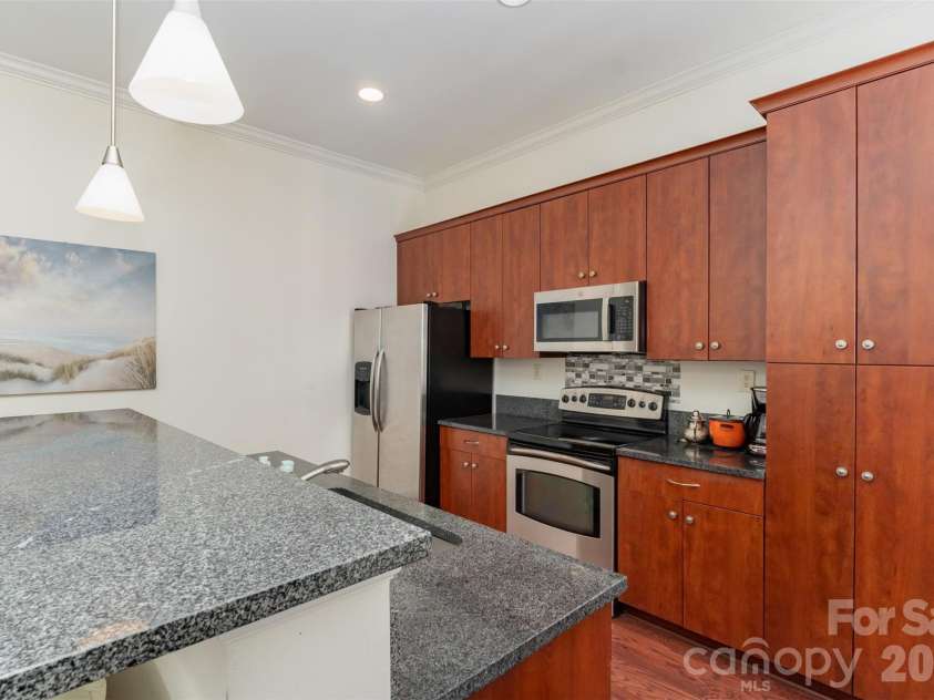 230 Tryon Street, Charlotte, NC 28202.  MLS# CAR4321048, YatesRealty ID 4611. View of Kitchen with back towards the windows
