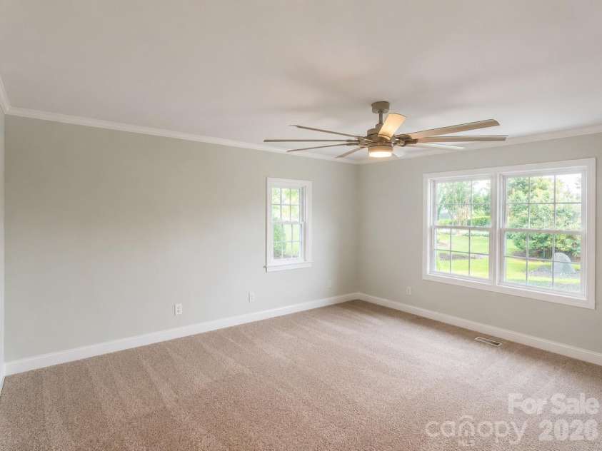 4904 Willow Pond Road, Clover, SC 29710.  MLS# CAR4412083, YatesRealty ID 46114. Primary bedroom with ample light and ceiling fan