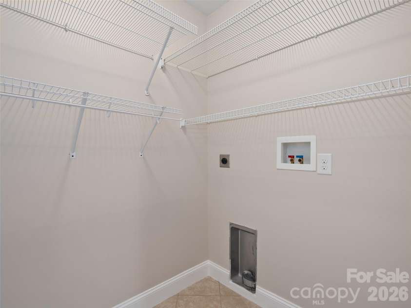 11 Tahchee Trail, Fletcher, NC 28732.  MLS# CAR4415640, YatesRealty ID 46135. Laundry Room Conveniently Located in Oversized Primary Closet