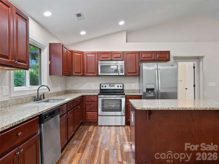 11 Tahchee Trail, Fletcher, NC 28732.  MLS# CAR4415640, YatesRealty ID 46135. Open Kitchen with Large Island and Stainless Appliances