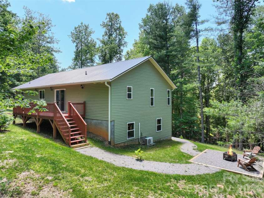 11 Tahchee Trail, Fletcher, NC 28732.  MLS# CAR4415640, YatesRealty ID 46135. Tranquil Firepit Area with Walking Path to both sides of house