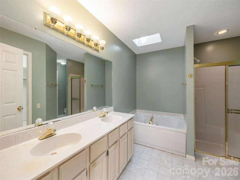 15 Glen Crest Drive, Arden, NC 28704.  MLS# CAR4416673, YatesRealty ID 46138. Primary Bath with Skylight