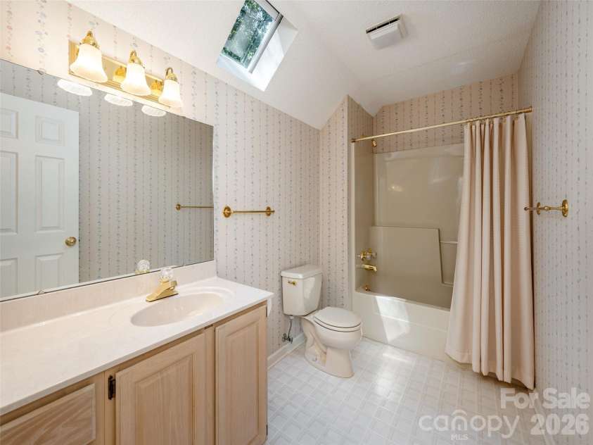 15 Glen Crest Drive, Arden, NC 28704.  MLS# CAR4416673, YatesRealty ID 46138. Upstairs Bath with Skylight