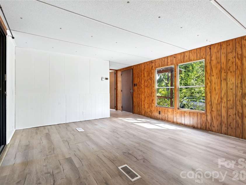 128 Pearson Circle, Lake Lure, NC 28746.  MLS# CAR4417256, YatesRealty ID 46151. Living room and dining area