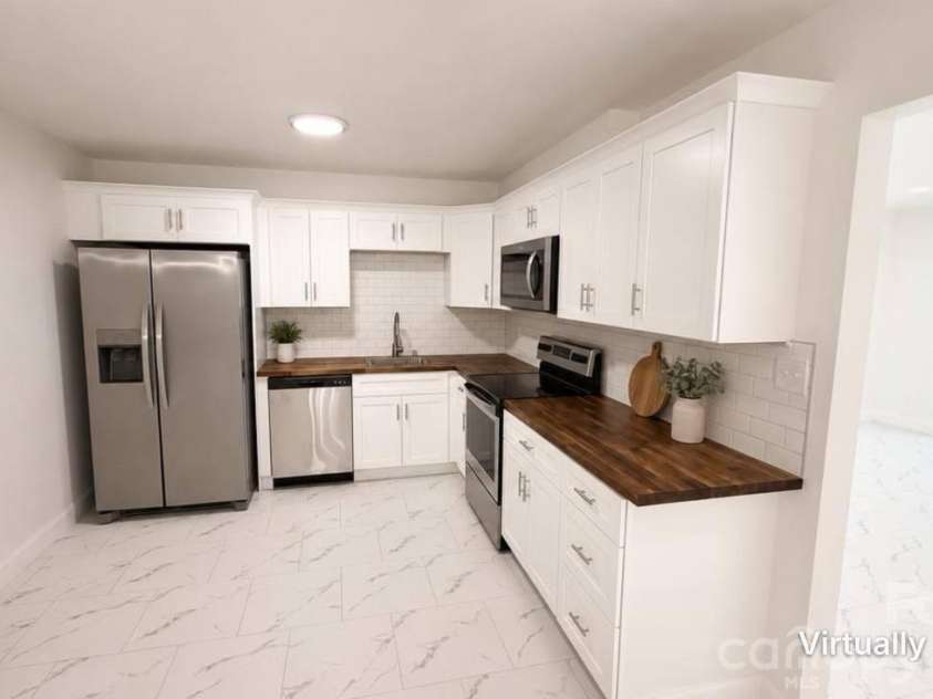 7107 Stonington Lane, Charlotte, NC 28227.  MLS# CAR4416930, YatesRealty ID 46171. AI staged kitchen