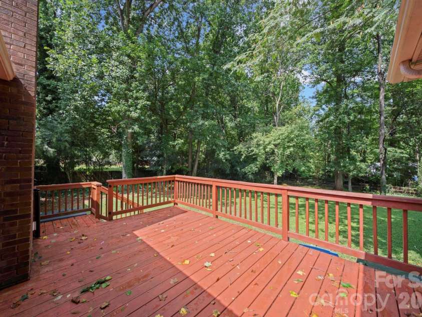 4710 Carving Tree Drive, Charlotte, NC 28227.  MLS# CAR4416653, YatesRealty ID 46194. Large deck off the living area with steps to the backyard