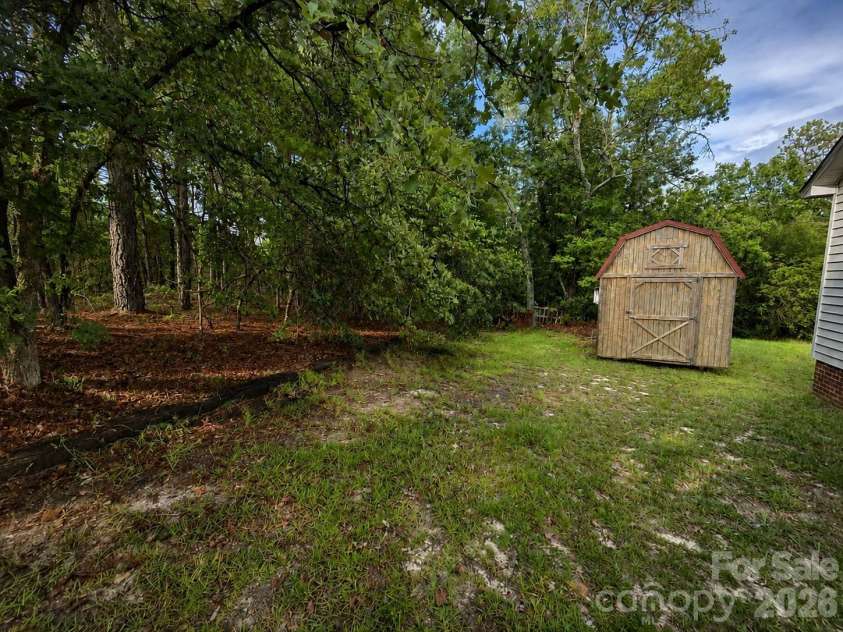 505 Addor Road, Pinebluff, NC 28373.  MLS# CAR4415997, YatesRealty ID 46198. Storage building w/ loft and cabinets, includes lean-to on the side