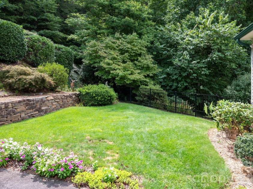 92 Lindon Cove Road, Candler, NC 28715.  MLS# CAR4415627, YatesRealty ID 46224. Level front yard.