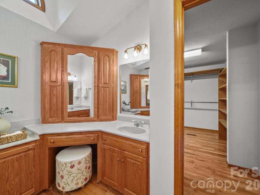 3008 Eaker Drive, Cherryville, NC 28021.  MLS# CAR4410929, YatesRealty ID 46228. The primary ensuite has a pocket door separating it from the bedroom, two sinks, a large soaking tub, a tiled shower, and a huge closet!