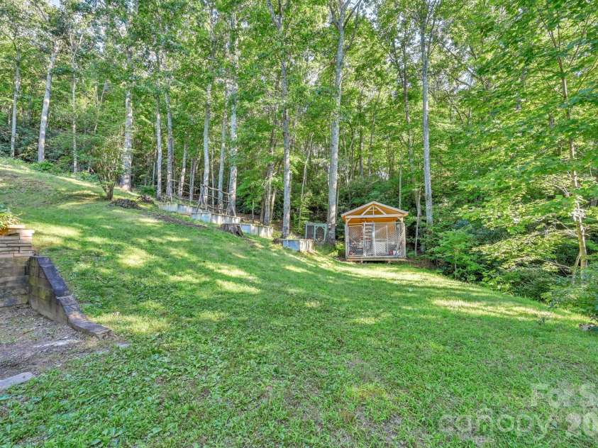426 Meadowood Lane, Burnsville, NC 28714.  MLS# CAR4412082, YatesRealty ID 46234. Side Yard to Storage