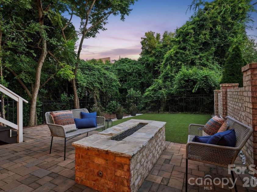 818 Ideal Way, Charlotte, NC 28203.  MLS# CAR4392342, YatesRealty ID 46239. Lower-level patio with firepit and turf area