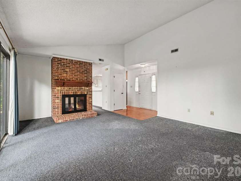 8248 Oakley Lane, Charlotte, NC 28270.  MLS# CAR4417219, YatesRealty ID 46249. Den with fireplace and access to back deck