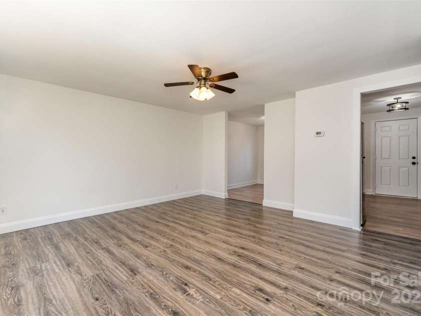 6847 Saddle Point Road, Charlotte, NC 28212.  MLS# CAR4237052, YatesRealty ID 4629. Living room looking into kitchen and dining room