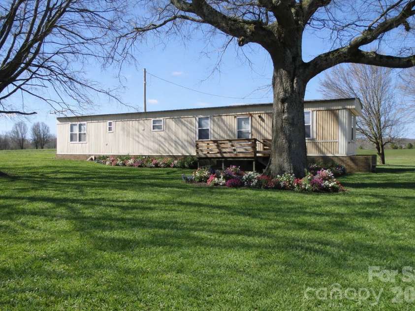 5750 New Hope Road, Denton, NC 27239.  MLS# CAR4350091, YatesRealty ID 4633. Virtually staged grass and flowers in front yard