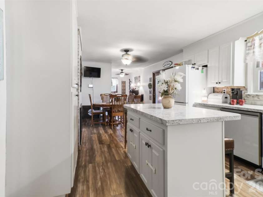 724 Hillcrest Drive, Bessemer City, NC 28016.  MLS# CAR4417402, YatesRealty ID 46359. The kitchen is designed with both function and gathering in mind, featuring a center island that adds valuable prep space and casual seating. A spacious pantry provides excellent storage for groceries, small applia
