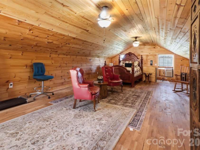 724 Hillcrest Drive, Bessemer City, NC 28016.  MLS# CAR4417402, YatesRealty ID 46359. This expansive upper-level room is filled with natural light from multiple windows and wrapped in beautiful wood on both the walls and ceiling, giving it a distinctive, welcoming feel. Its impressive size provides 