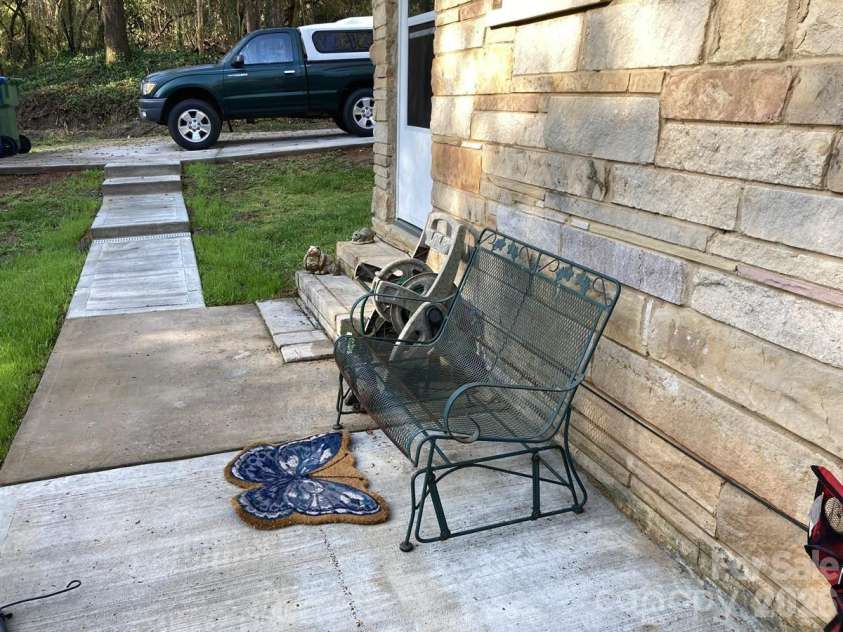 216 Auten Circle, Mount Holly, NC 28120.  MLS# CAR4416875, YatesRealty ID 46378. Concrete patio off back door perfect for bbq, firepit overlooking wooded backyard