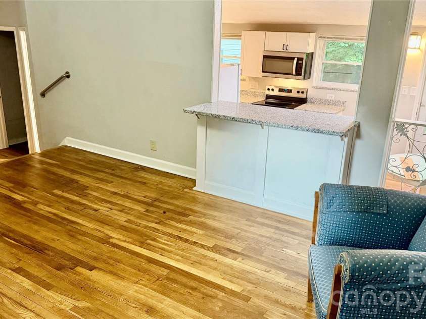 216 Auten Circle, Mount Holly, NC 28120.  MLS# CAR4416875, YatesRealty ID 46378. Eat-in bar overlooking kitchen opening.
