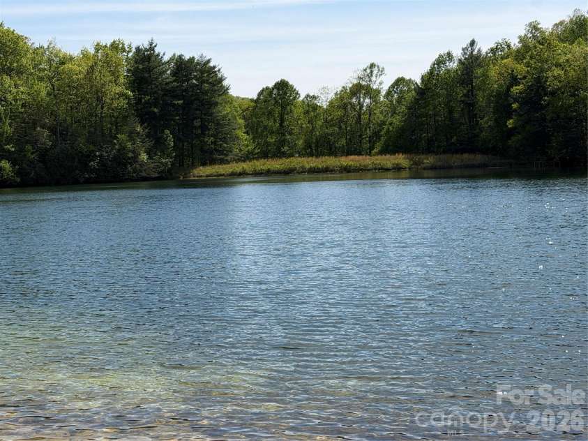 327 Summit Road, Tryon, NC 28782.  MLS# CAR4417439, YatesRealty ID 46395. Community swimming lake