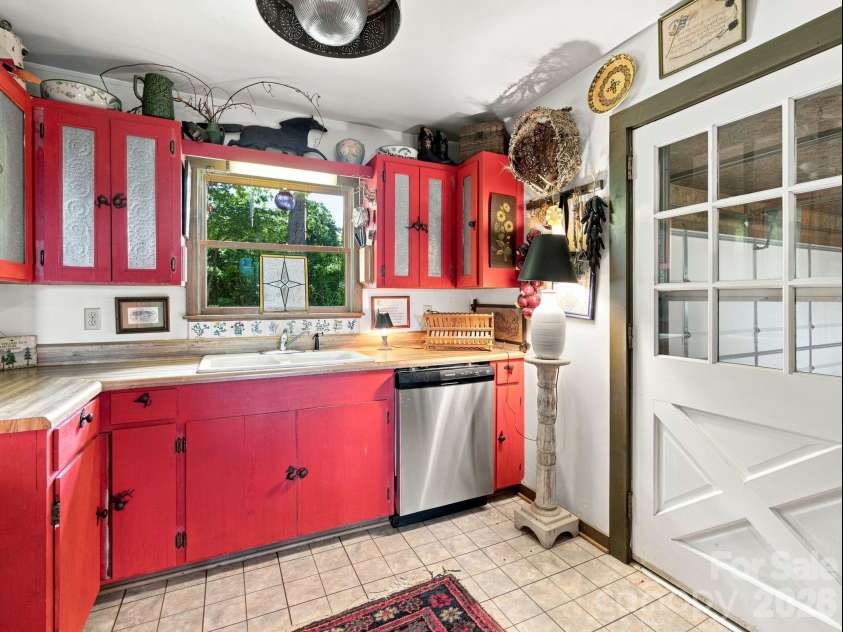 327 Summit Road, Tryon, NC 28782.  MLS# CAR4417439, YatesRealty ID 46395. Door leads to the attached two-car garage