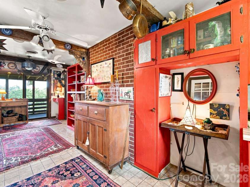 327 Summit Road, Tryon, NC 28782.  MLS# CAR4417439, YatesRealty ID 46395. From the kitchen looking toward the screen porch