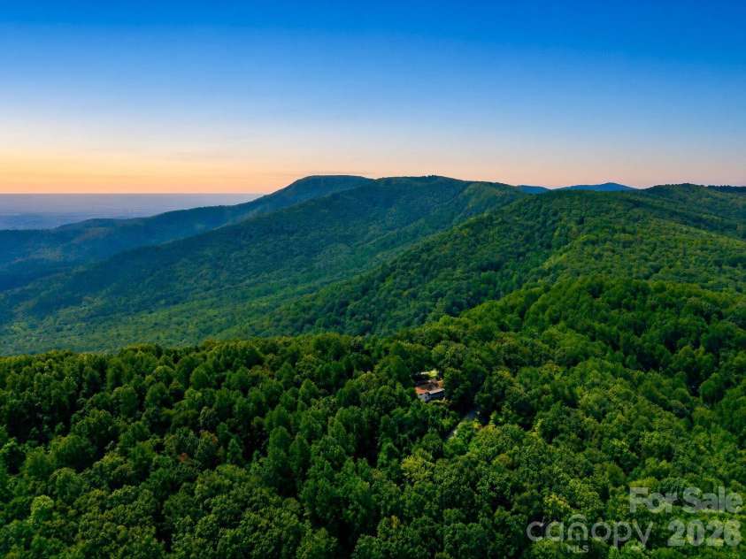 327 Summit Road, Tryon, NC 28782.  MLS# CAR4417439, YatesRealty ID 46395. Nestled in the trees