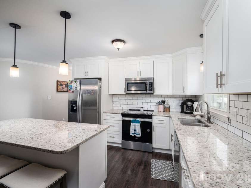 1718 Woolie Road, Lincolnton, NC 28092.  MLS# CAR4417317, YatesRealty ID 46404. Kitchen with white shaker cabinets