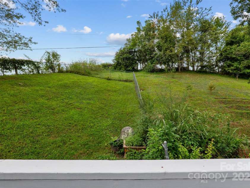 271 Breton Ridge Road, Leicester, NC 28748.  MLS# CAR4284121, YatesRealty ID 4642. Private back yard with fruit trees and fenced area