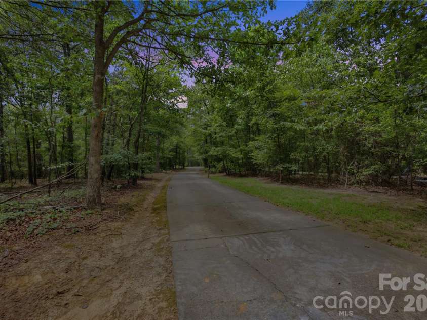 4006 Old Pageland Marshville Road, Wingate, NC 28174.  MLS# CAR4416227, YatesRealty ID 46432. As you make your way back down the tree-lined drive, the peaceful setting really lingers—the kind of quiet, private arrival and departure that makes this property feel like a retreat from the moment you tur