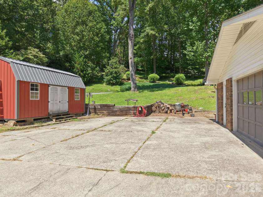 339 Indian Hills Loop, Waynesville, NC 28786.  MLS# CAR4417472, YatesRealty ID 46453. Driveway and workshop
