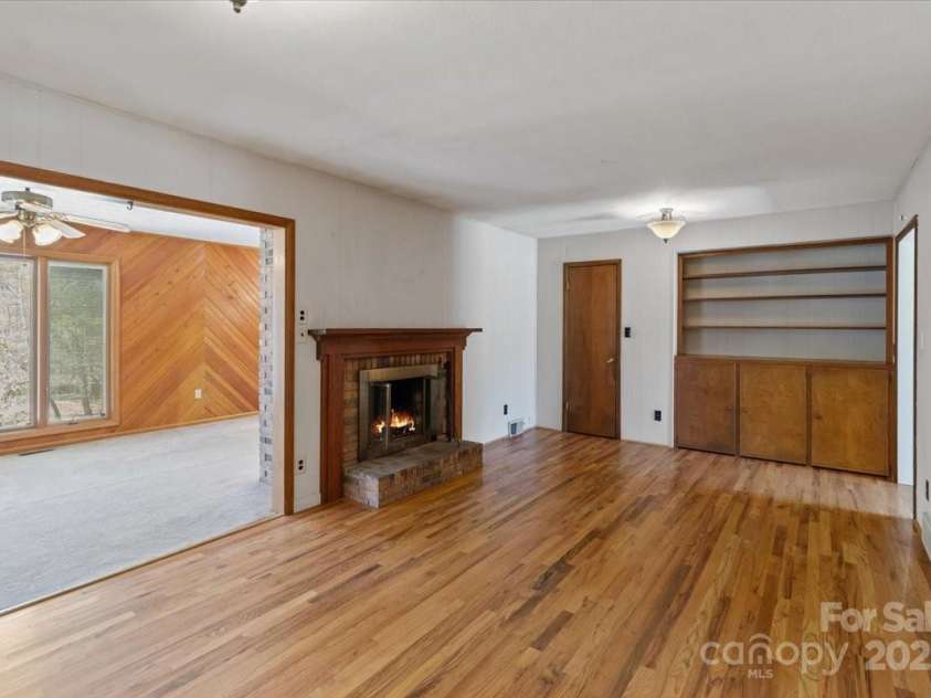 10 W Baird Mountain Road, Asheville, NC 28804.  MLS# CAR4234324, YatesRealty ID 4646. Den with wood burning fireplace, wood floors