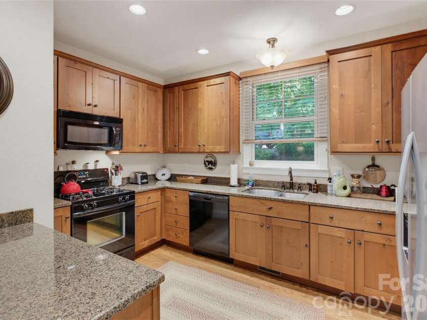 298 Hedgewood Drive, Tuckasegee, NC 28783.  MLS# CAR4393435, YatesRealty ID 46529. Kitchen opens to living area open concept