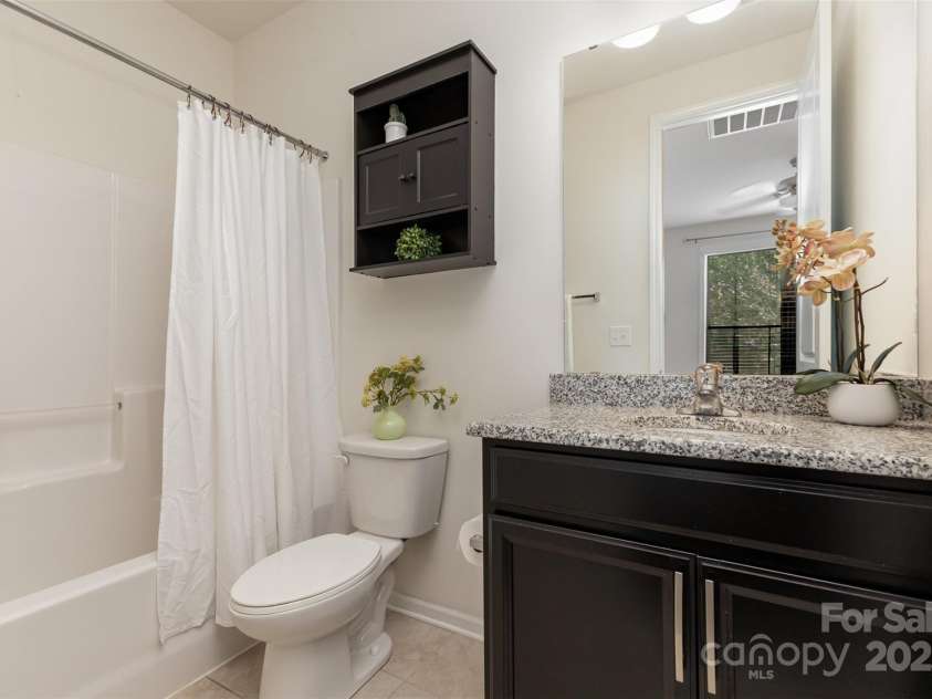 8651 Shadetree Street, Huntersville, NC 28078.  MLS# CAR4284717, YatesRealty ID 4653. En suite downstairs bathroom