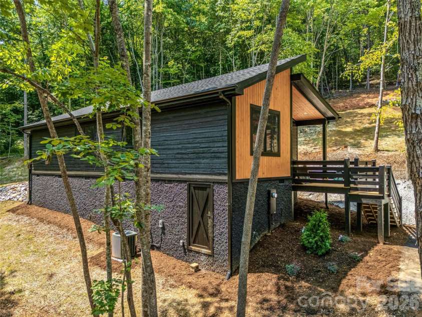 60 Catatoga Trail, Marion, NC 83452.  MLS# CAR4403563, YatesRealty ID 46556. Side exterior nestled in the trees