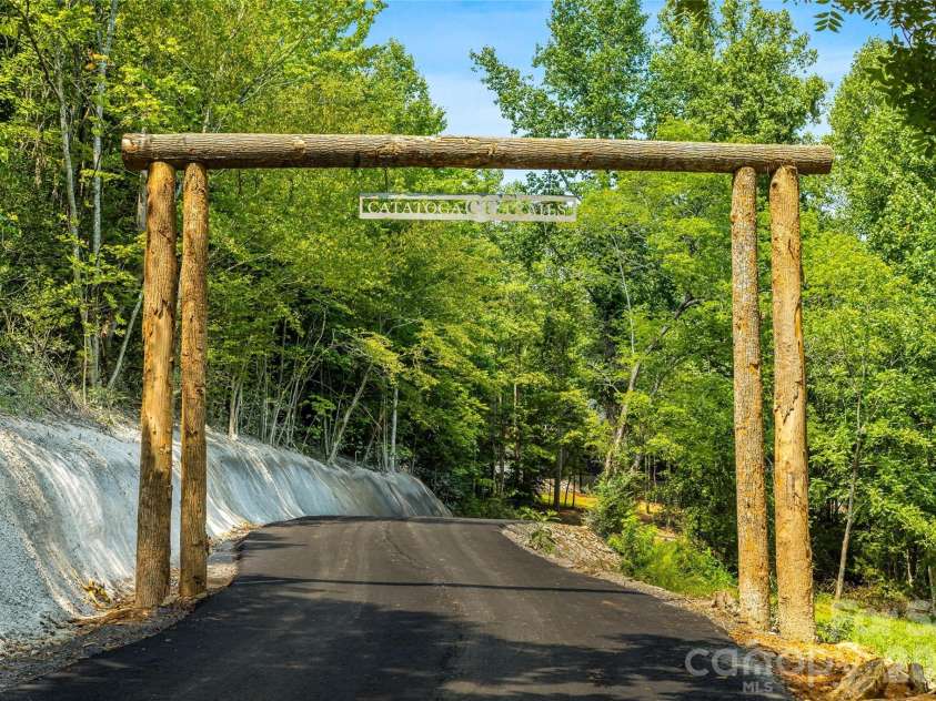 60 Catatoga Trail, Marion, NC 83452.  MLS# CAR4403563, YatesRealty ID 46556. Wooded approach to the community
